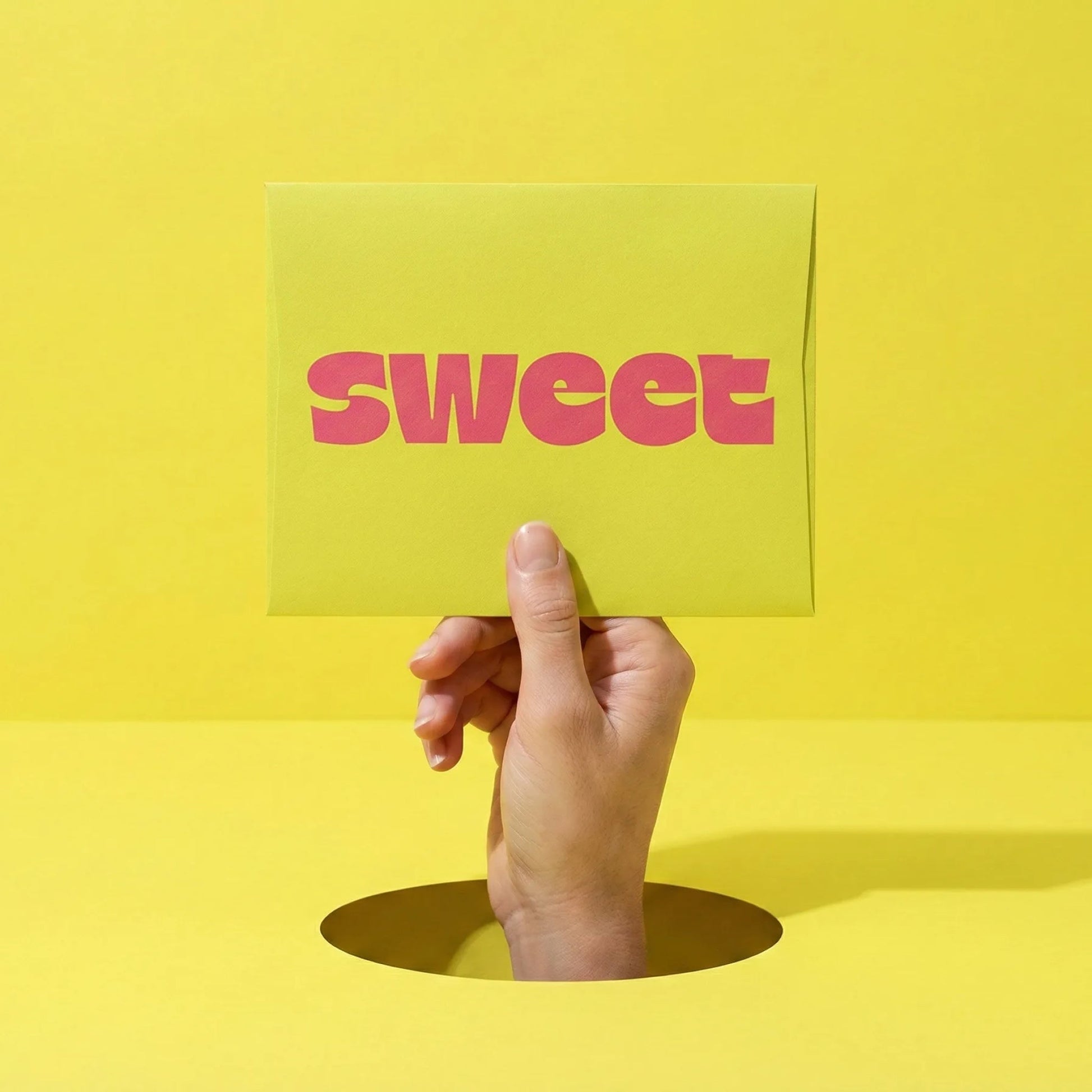 A SWEET Love Letter — a hand rising through a hole in a yellow floor holding up a card reading sweet