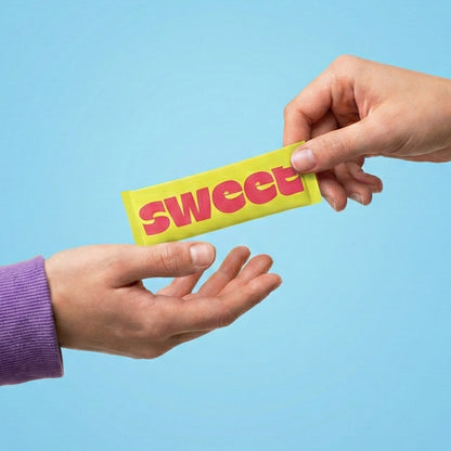 A SWEET Love Letter — two hands passing a stick packet between them against a blue background