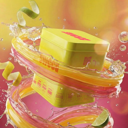 SWEET square tin floating amid swirling citrus liquid with ice cubes and curled lime peel