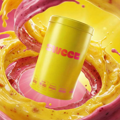 Yellow SWEET tin floating in a swirl of pink-and-yellow smoothie liquid